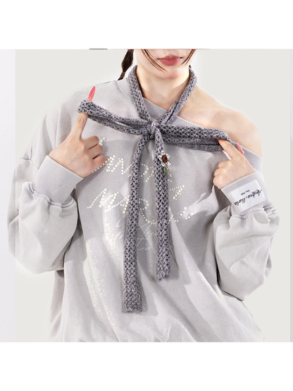 Heather Gray skinny scarf styled in a loose shoulder knot