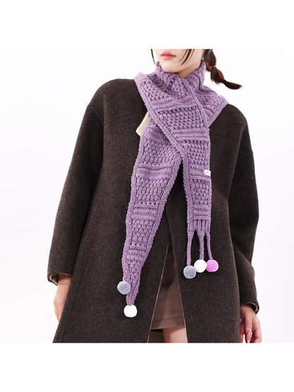 Heather Purple tapered scarf worn crossed at the neck with pom-pom-tipped ties