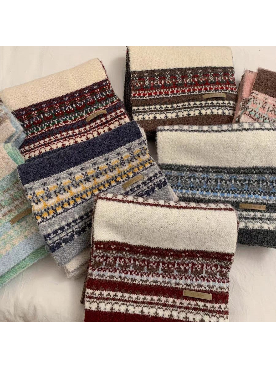 Multiple geometric-pattern scarf colors displayed together