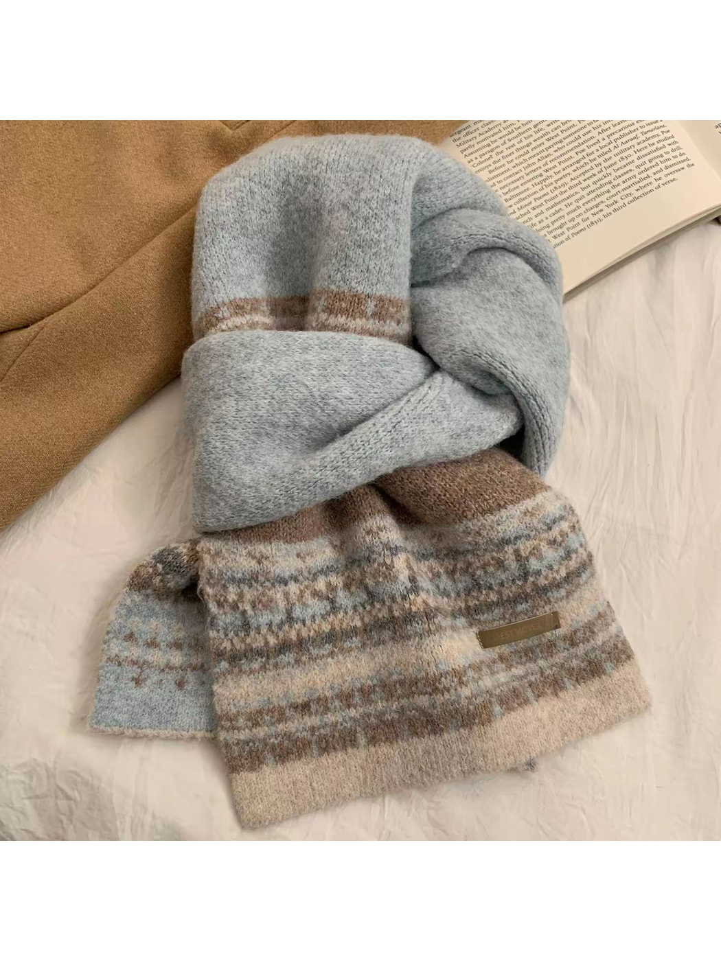 Blue geometric-pattern scarf arranged in a knotted flat lay