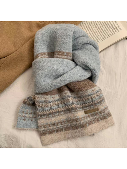 Blue geometric-pattern scarf arranged in a knotted flat lay