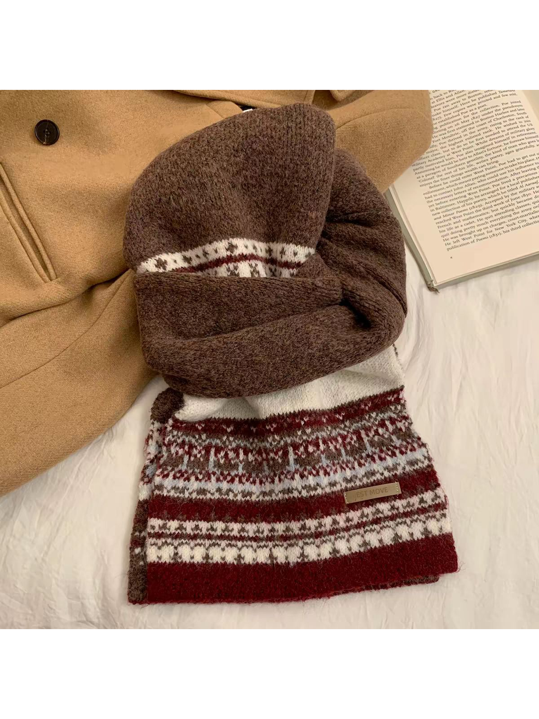 Brown and burgundy geometric-pattern scarf arranged in a knotted flat lay