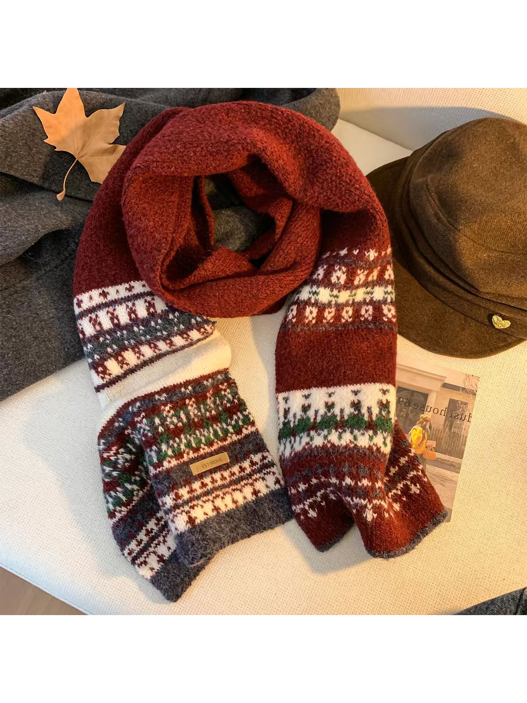 Burgundy geometric-pattern scarf arranged with fall accessories