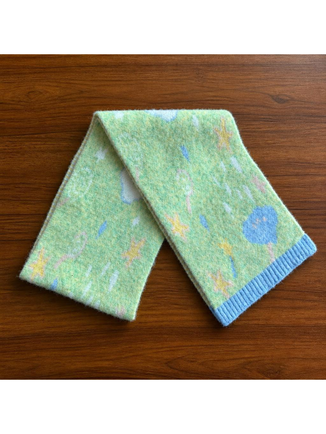 Moon patterned scarf with blue ribbed ends, full view