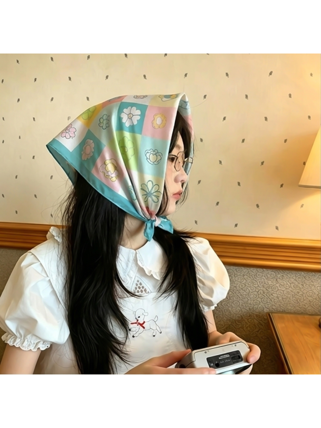 Floral checkerboard square scarf folded into a triangle and tied under the chin