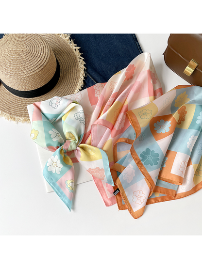 Three floral checkerboard square scarves arranged in mint, pink and orange colorways