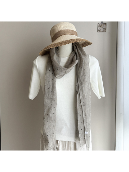 Greige dotted scarf styled on a white mannequin with a wide-brim hat