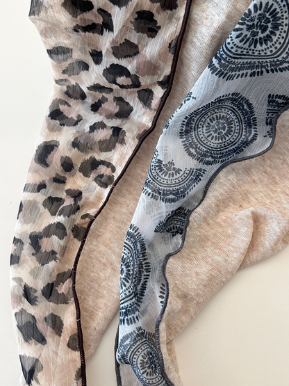 Close-up of printed triangle scarves with contrast edge finishes