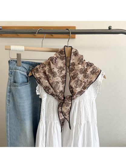 Rose Floral triangle scarf tied over a white dress