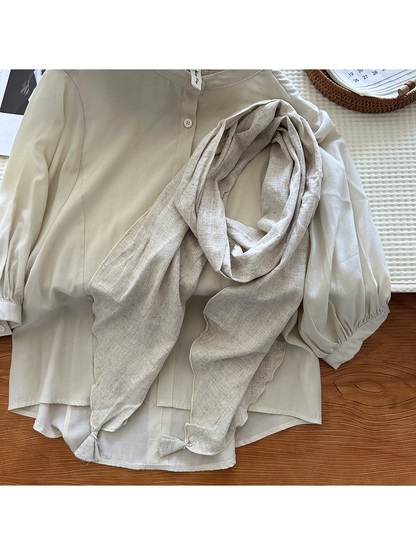 Ivory tassel scarf styled over a light blouse