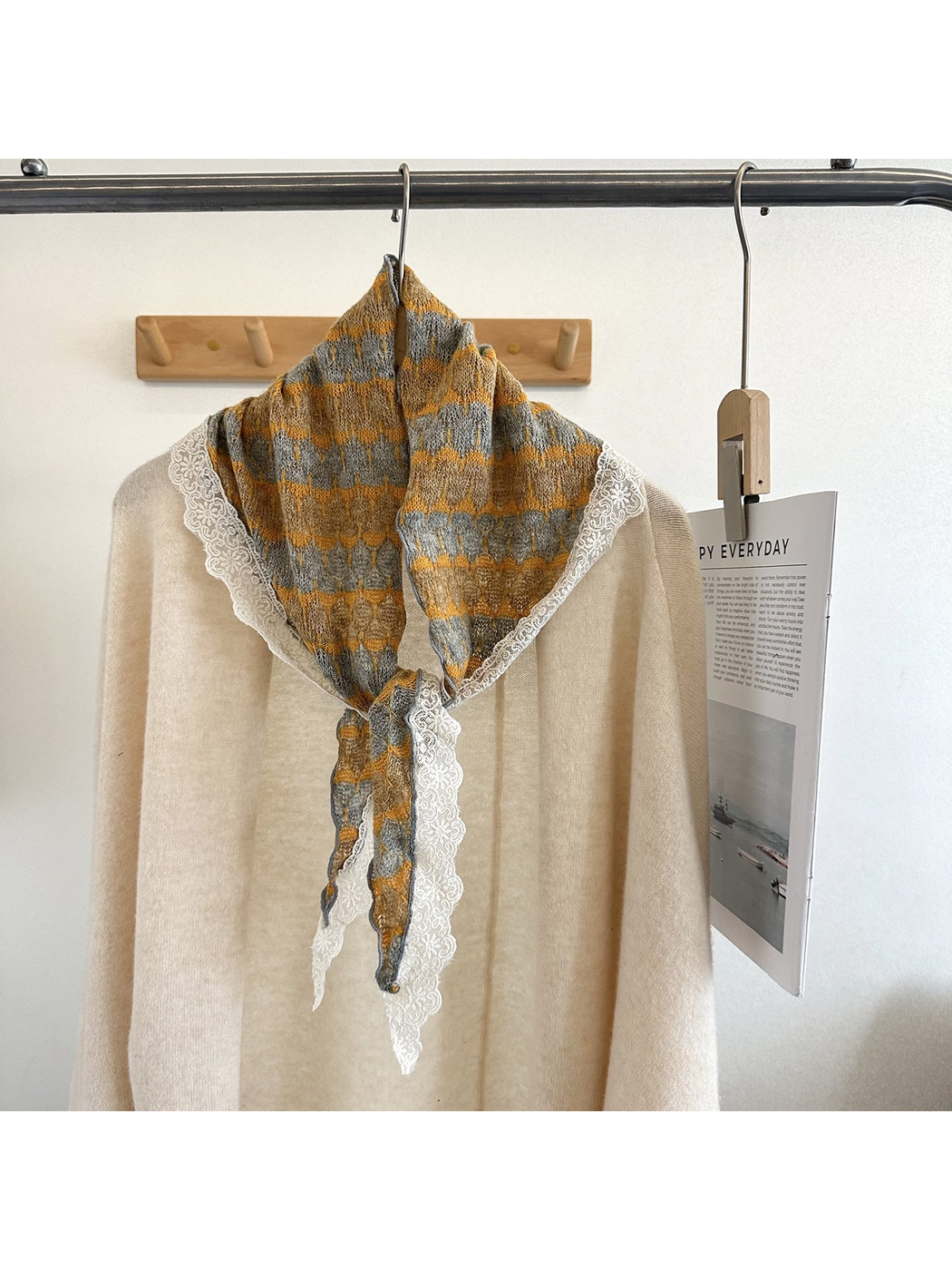Yellow and gray striped triangle scarf styled over a cream top
