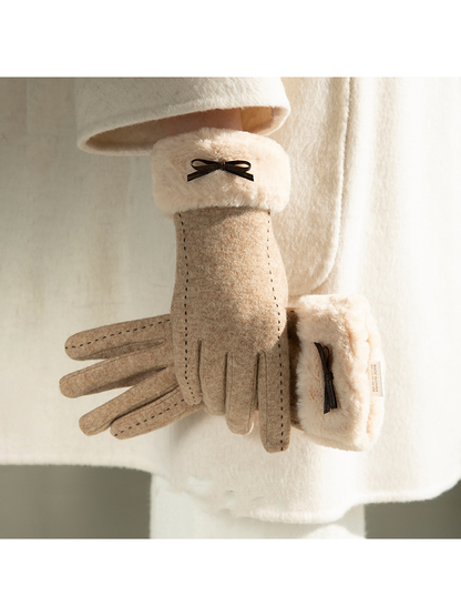 Beige gloves with bow accents styled against a light coat