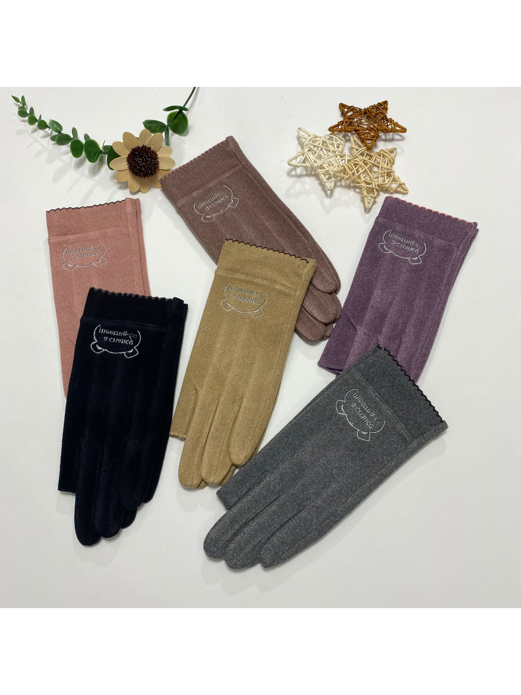 Six colors of fingerless gloves arranged with decorative flowers and stars