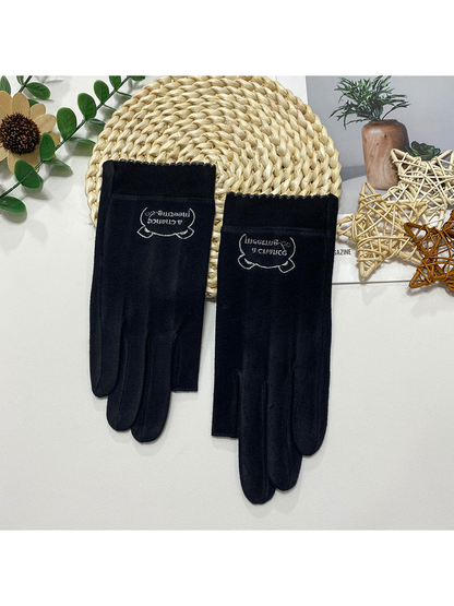 Black fingerless gloves with a small embroidered cuff emblem