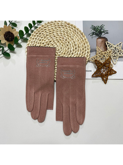 Dusty Pink fingerless gloves with a small embroidered cuff emblem