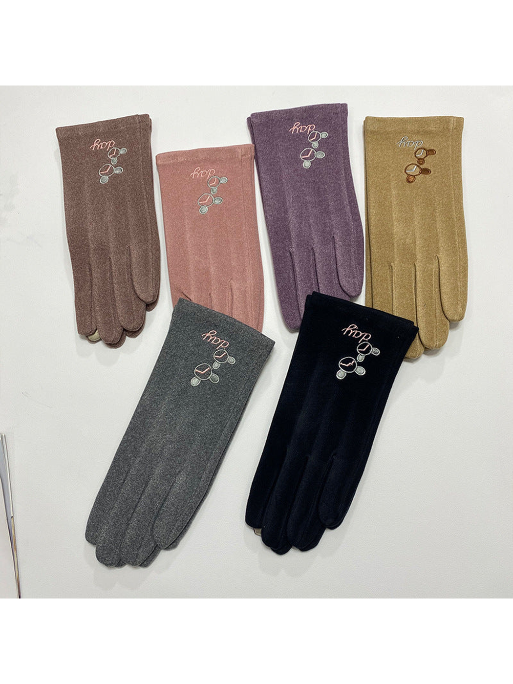 Six color variants of embroidered gloves displayed together