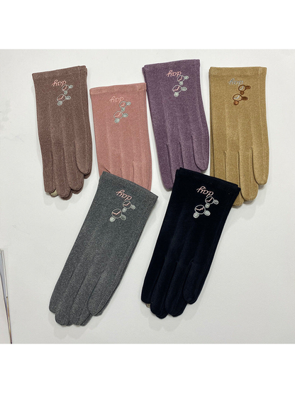 Six color variants of embroidered gloves displayed together
