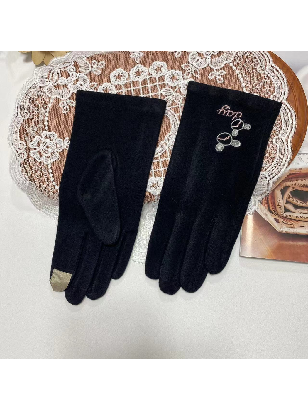 Black gloves with linked-circle embroidery and contrast fingertip patch