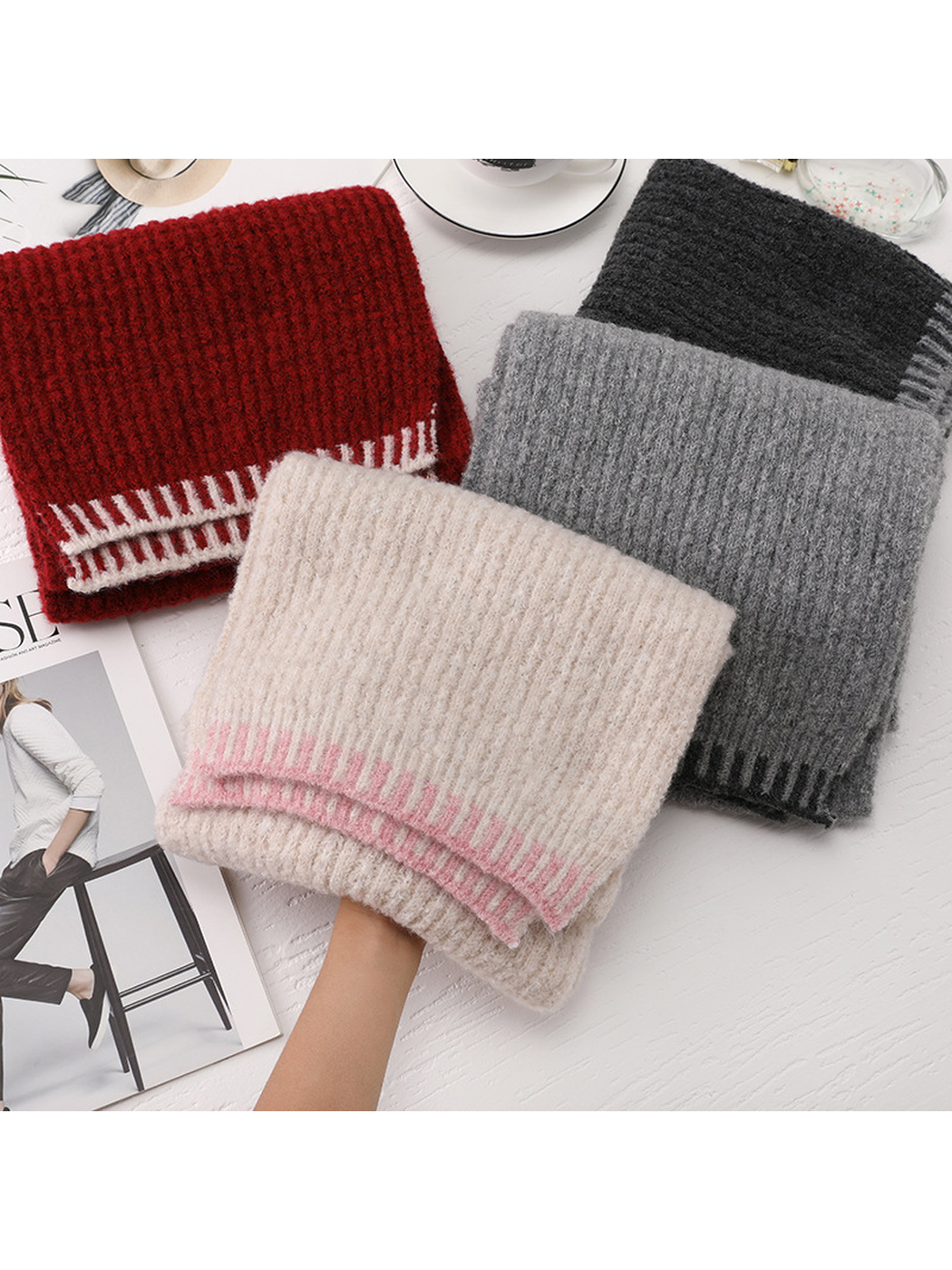 Four scarf colors folded together with the beige scarf held in front