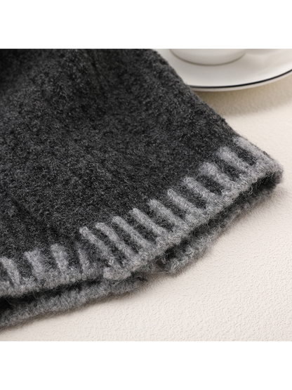 Close-up of dark gray fuzzy texture and light gray barred end border