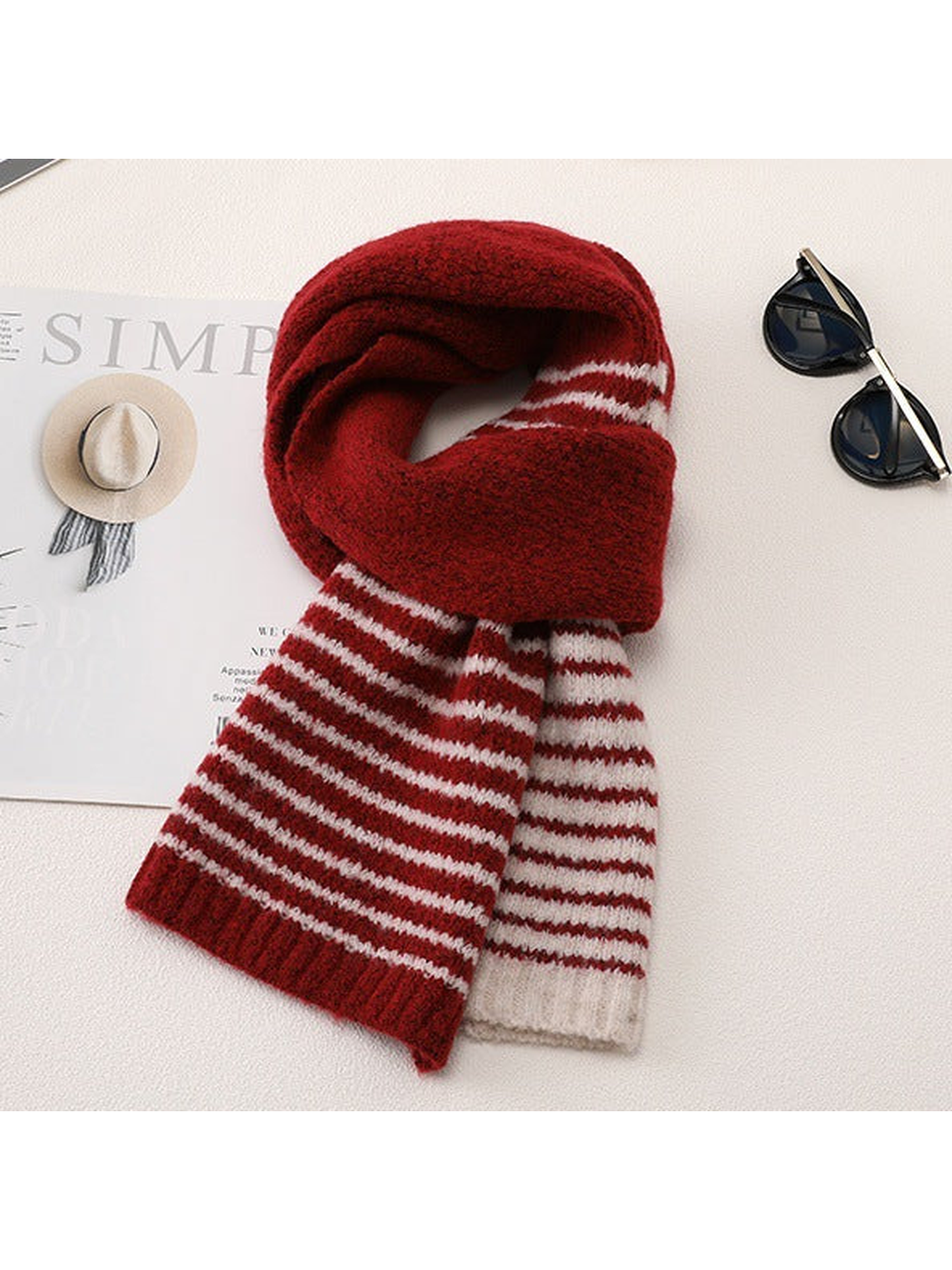Red striped scarf arranged in a draped tabletop display