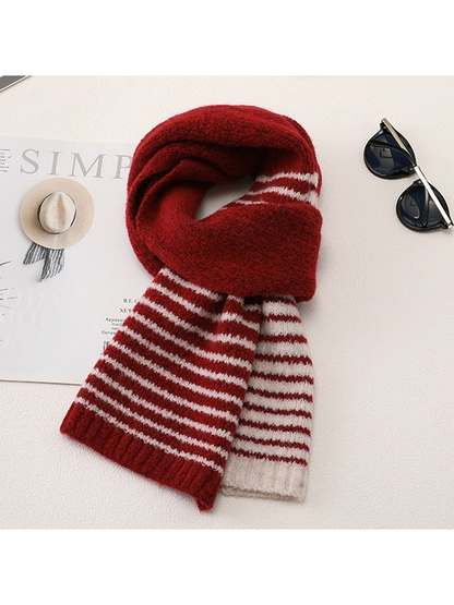 Red striped scarf arranged in a draped tabletop display