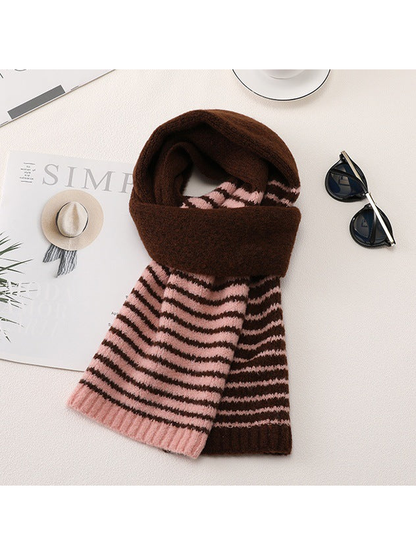 Brown and pink striped scarf arranged in a draped tabletop display