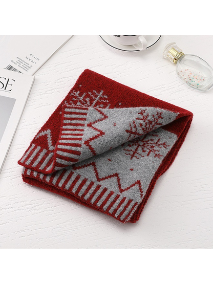 Folded red scarf showing the contrasting reverse pattern and striped border