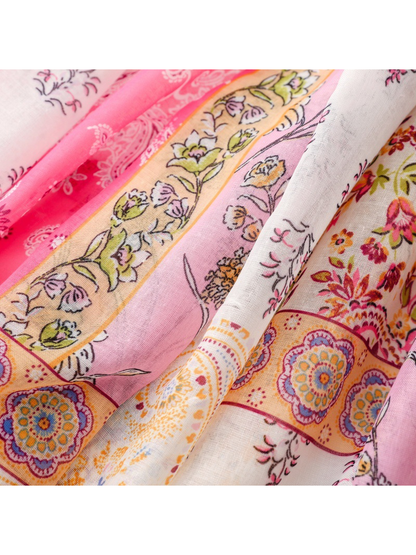 Close-up of the pink, cream and orange patchwork-style floral and medallion print