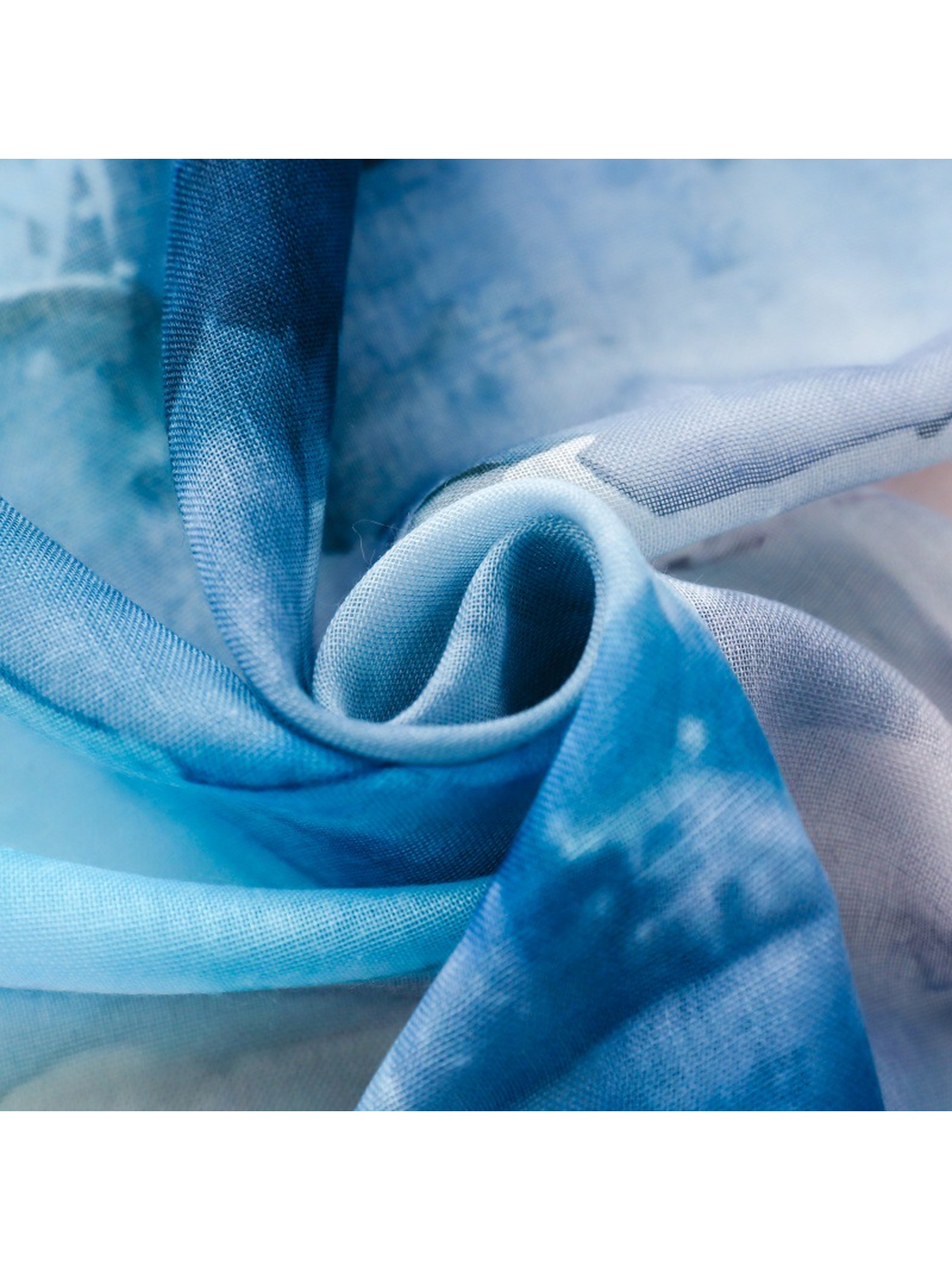Close-up of the scarf's fine grid-like surface texture and blue pattern