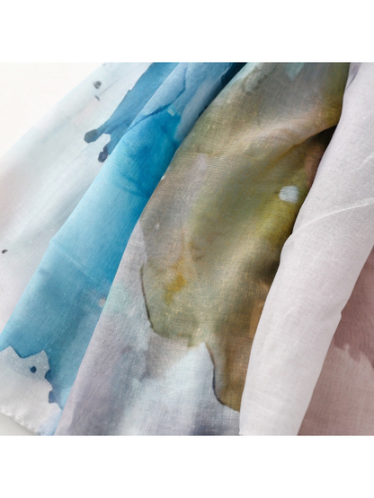 Close-up of the scarf's semi-sheer surface and layered watercolor-style colors