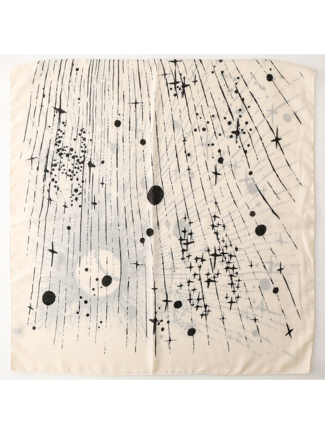 Ivory scarf laid flat with scattered stars, dots, and fine black lines