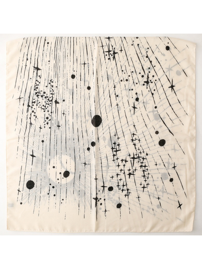 Ivory scarf laid flat with scattered stars, dots, and fine black lines