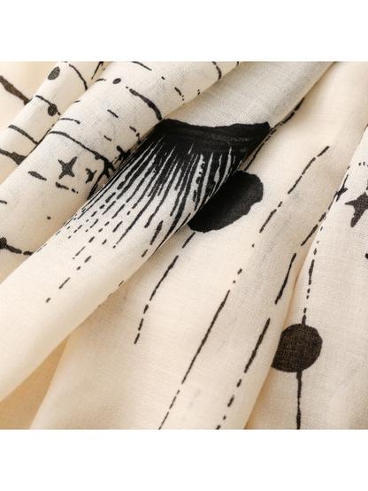 Close-up of the Ivory scarf's radiating motif, dots, and fine weave