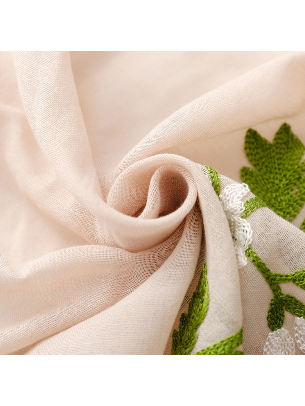 Close-up of the Beige scarf's fine semi-sheer weave beside floral embroidery