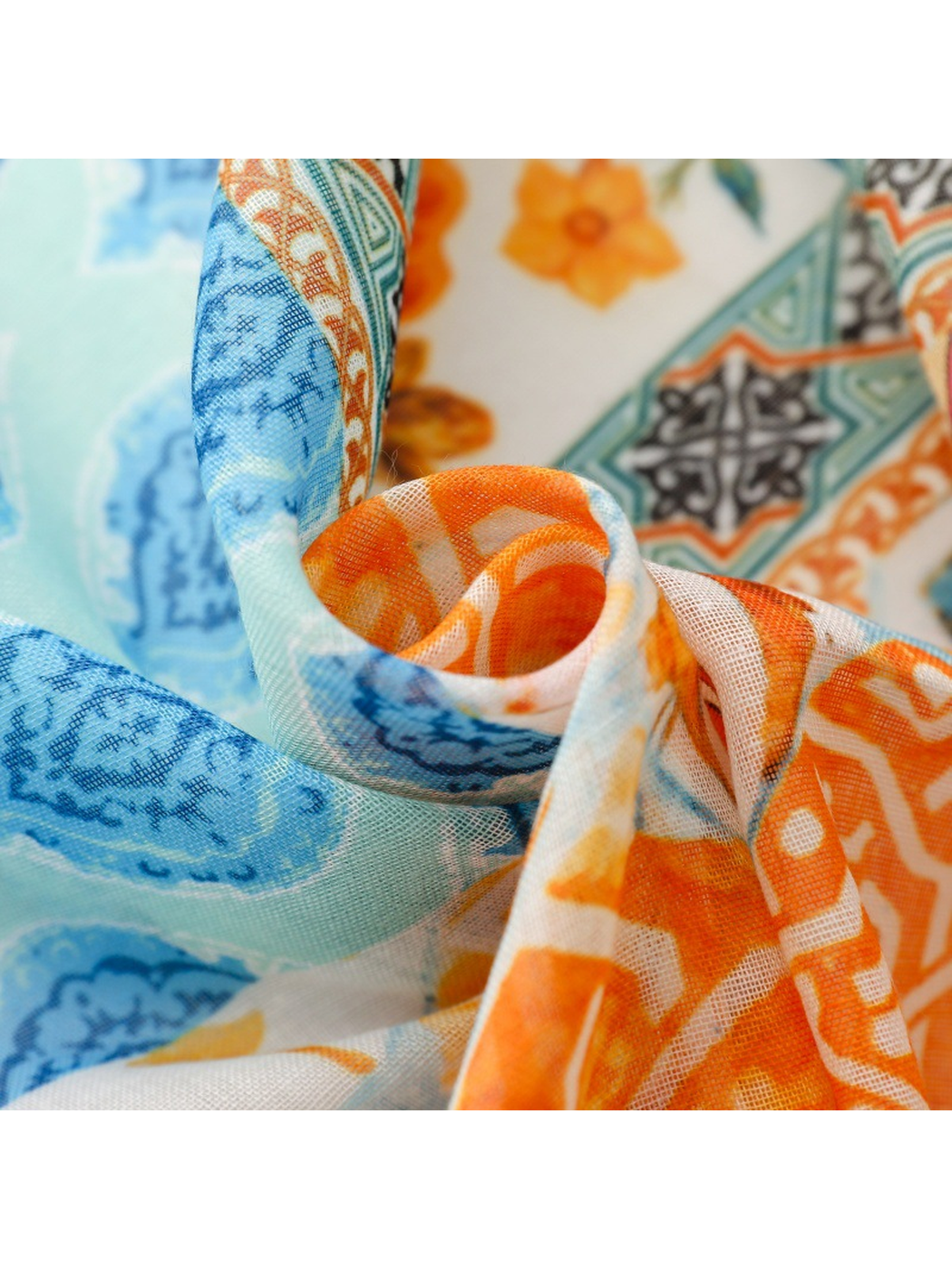 Close-up of the scarf's fine open weave and blue and orange print
