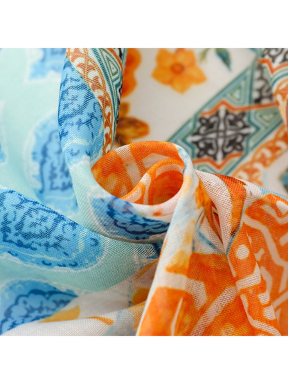 Close-up of the scarf's fine open weave and blue and orange print