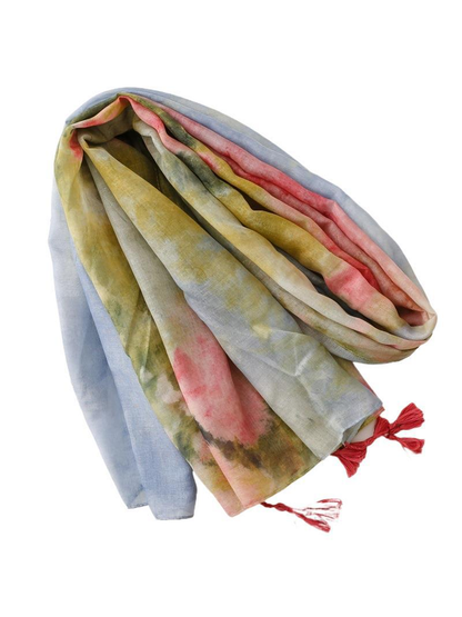 Multicolor abstract-pattern scarf draped in loose folds with red tassels