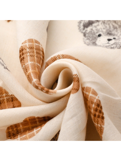Close-up of the ivory scarf weave and teddy bear print