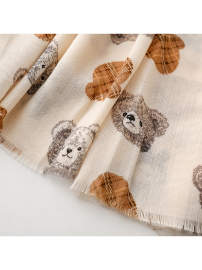 Close-up of the ivory scarf teddy bear print and short fringed edge