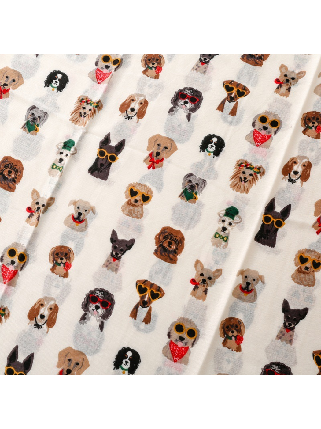 Close-up of the repeating dog portrait print on the Ivory scarf