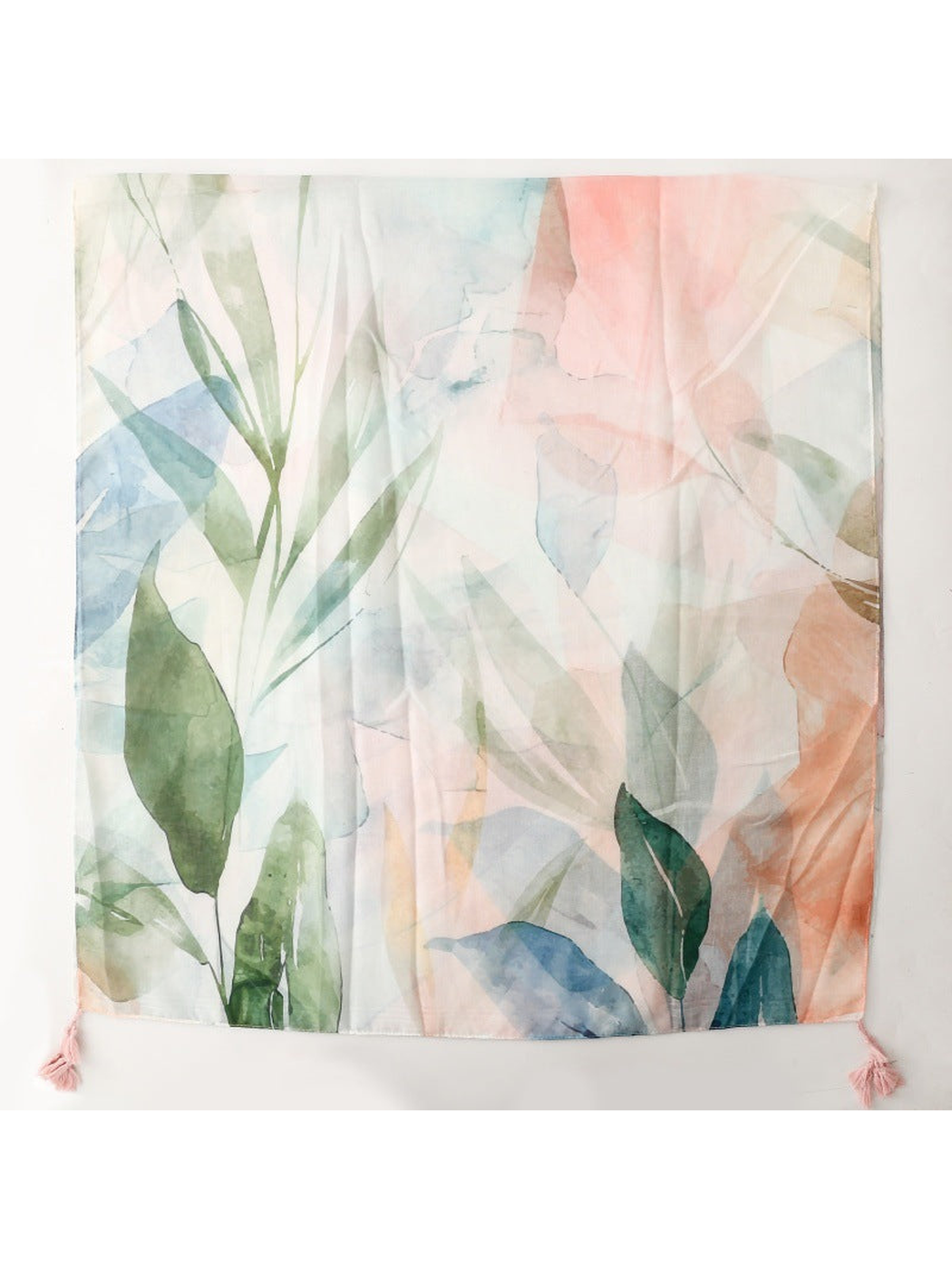 Multicolor watercolor botanical scarf laid flat with pink corner tassels