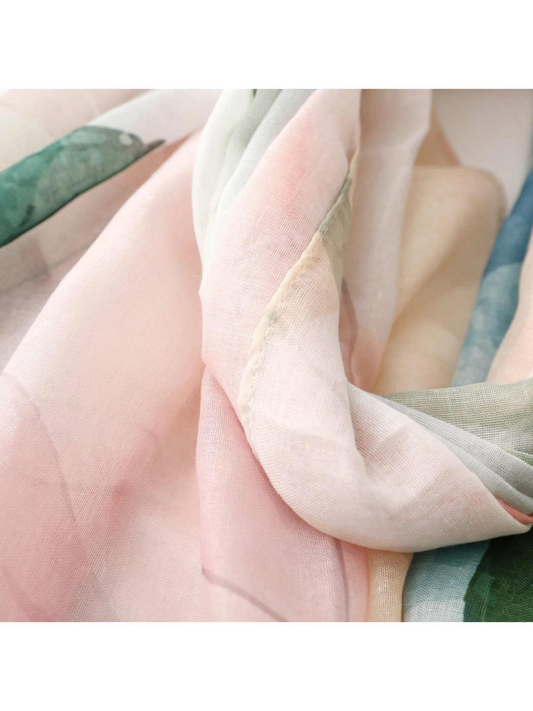 Close-up of the scarf's stitched edge and translucent pastel layers