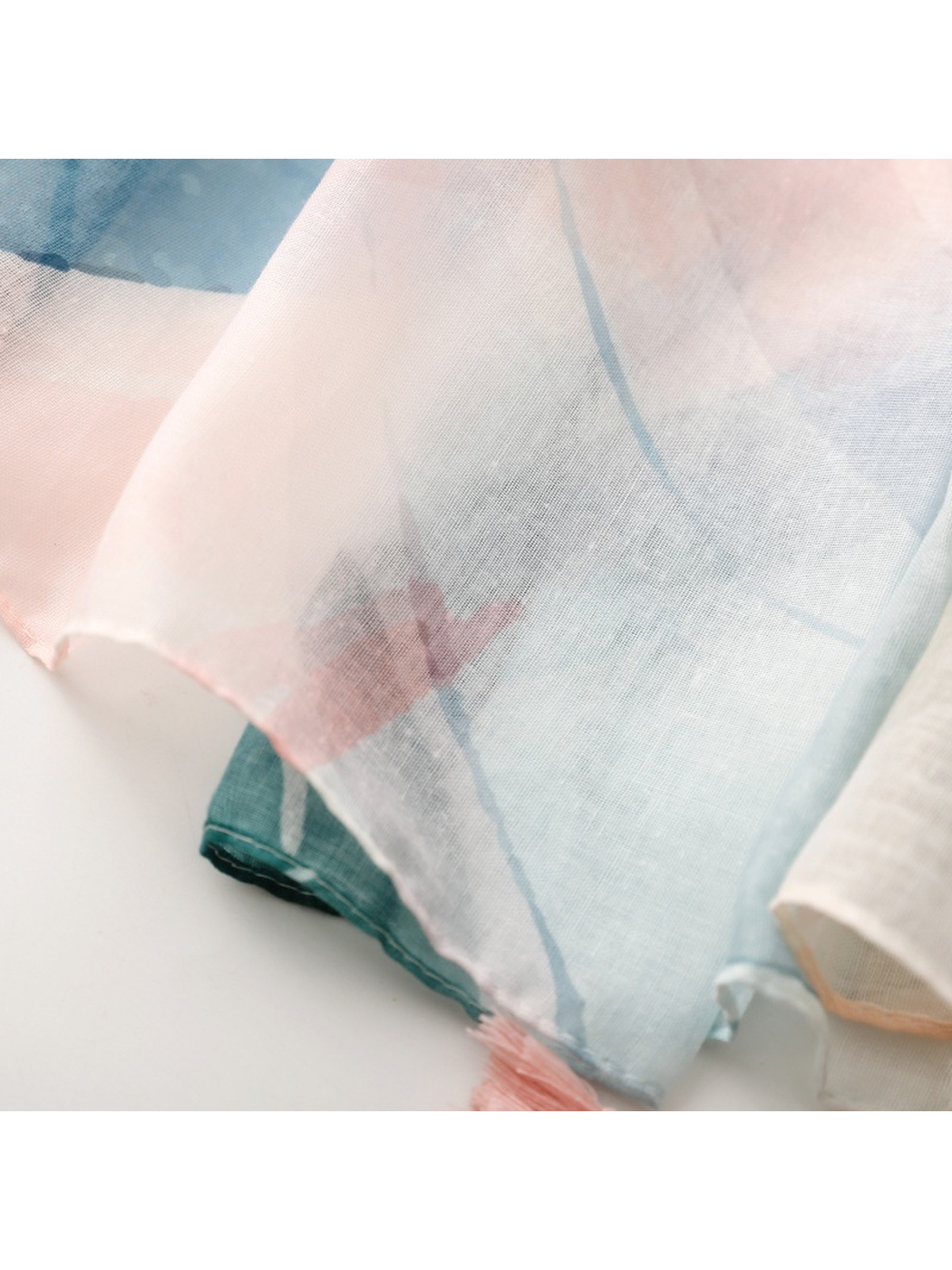 Close-up of a pink corner tassel and semi-sheer botanical pattern