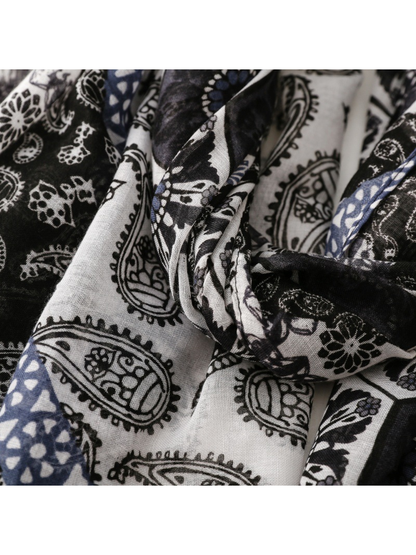 Close-up of contrasting black and white paisley sections with blue accents
