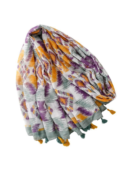 Multicolor patterned scarf with gray-green border and tassels, draped view