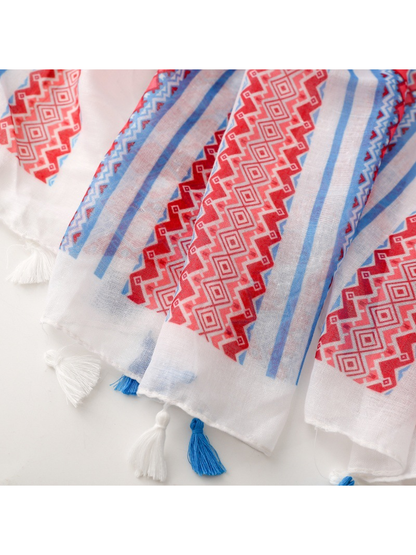 Close-up of white and blue knotted tassels and a red geometric border