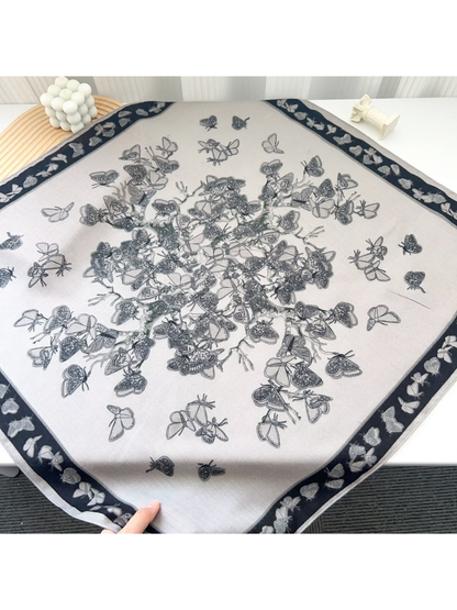 Light Gray butterfly-pattern square scarf laid flat with a dark border