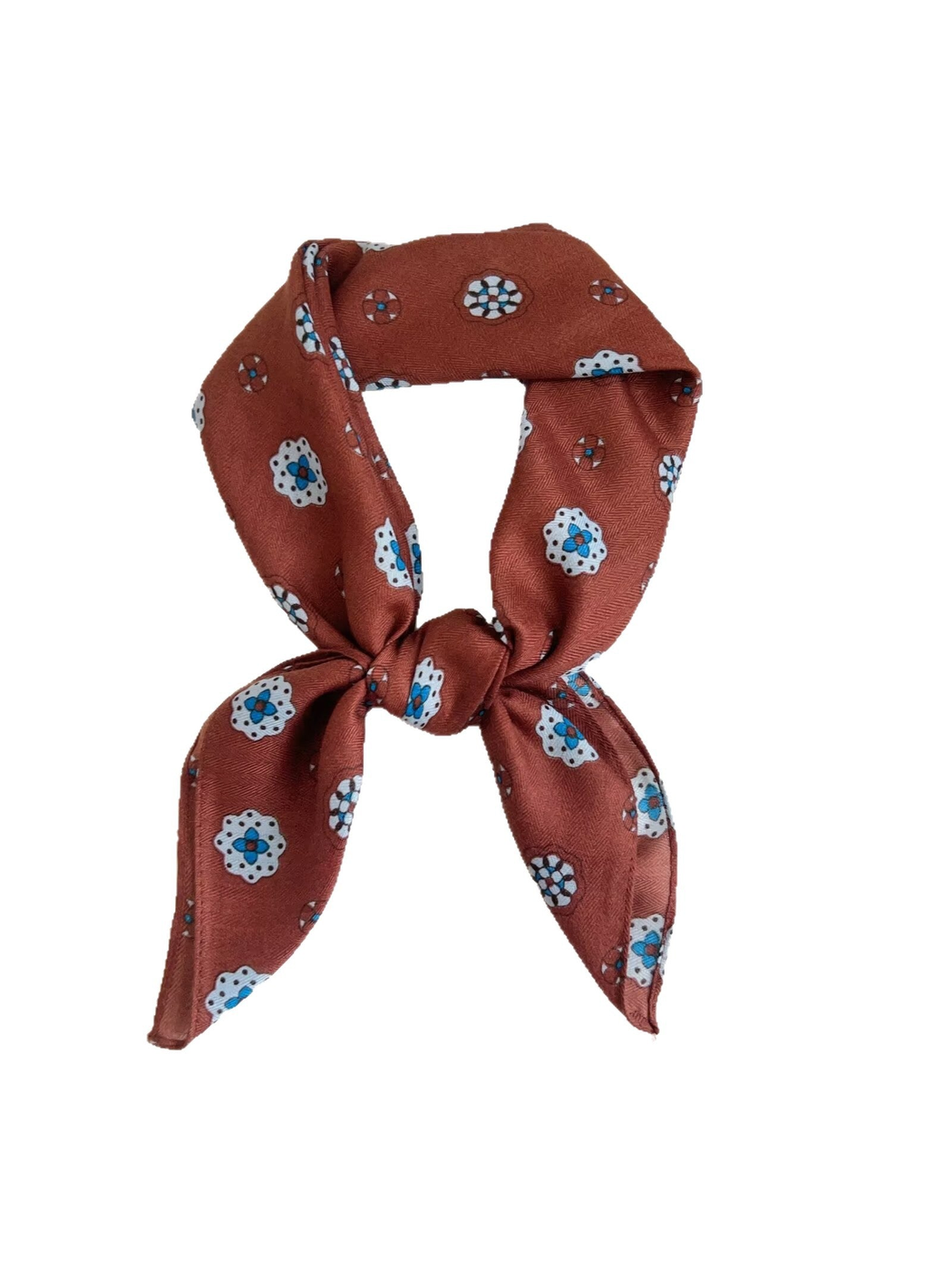 Orange red medallion-pattern square scarf tied in a dimensional loop