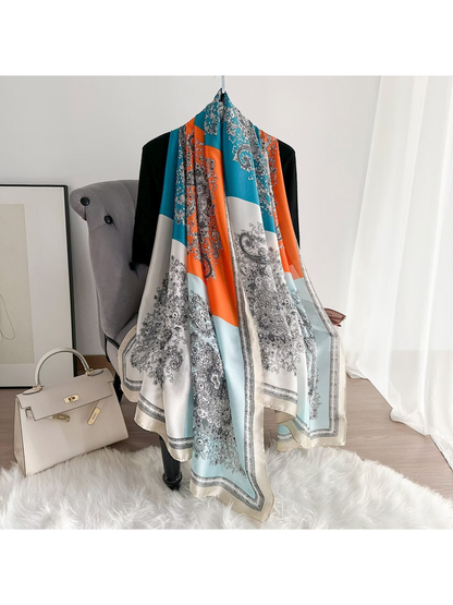 Teal, orange and ivory color-block paisley scarf draped at full length